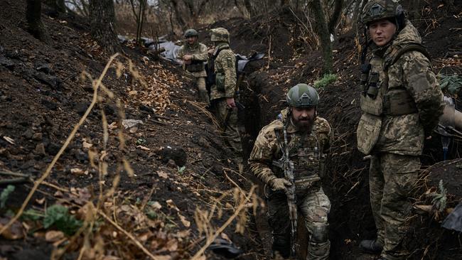 Soldiers of the 58th separate mechanised brigade go to their positions along the trenches, which are covered in mud after the rain on November 6, 2023 in Vuhledar, Ukraine. Picture: Kostya Liberov/Libkos via Getty Images