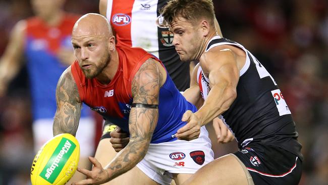 Nathan Jones handballs under pressure from Mav Weller. Picture: Michael Klein