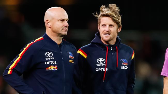 Coach Matthew Nicks and injured captain Rory Sloane talk during Monday night’s game against the Saints. Picture: Daniel Kalisz/Getty Images