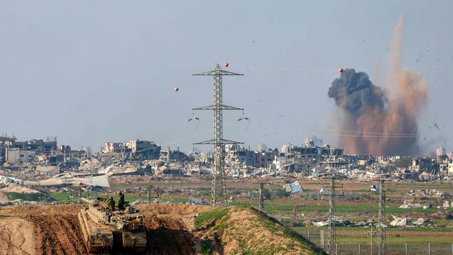 This picture taken from a position in southern Israel, on the border with Gaza, shows smoke billowing over the Palestinian territory during Israeli bombardment as an Israeli tank takes position on January 16, 2024, amid ongoing battles between Israel and Hamas. Picture: AFP