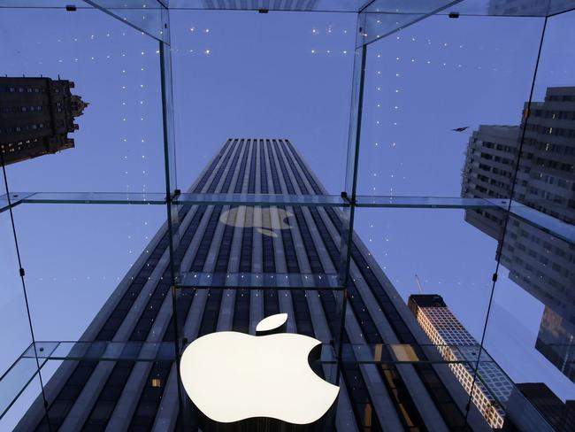 FILE - In this Sept. 5, 2014 file photo, the Apple logo hangs in the glass box entrance to the company's Fifth Avenue store, in New York. Apple, already the world's most valuable company, surpassed $700 billion in market capitalization Tuesday, Nov. 26, 2014, as its stock hit another all-time high. (AP Photo/Mark Lennihan, File)