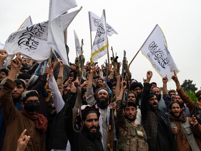 KABUL, AFGHANISTAN - AUGUST 15: Men wave the flag of the Islamic Emirate of Afghanistan during a celebration of the first anniversary of the Taliban's return to power on August 15, 2022 in Kabul, Afghanistan. A year after the Taliban retook Kabul, cementing their rule of Afghanistan after a two-decade insurgency, the country is beset by economic and humanitarian crises. Western governments have frozen billions of dollars in Afghan assets as it presses the Taliban to honor unmet promises on security, governance and human rights, including allowing all girls to be educated. (Photo by Nava Jamshidi/Getty Images) *** BESTPIX ***