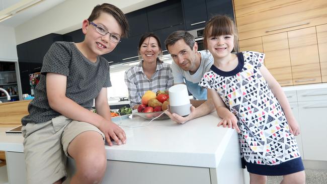 Harry, 8, Amanda, Michael and Elsie, 6, Boon of Kingston try the new Google Home device in their home. Picture: Luke Bowden