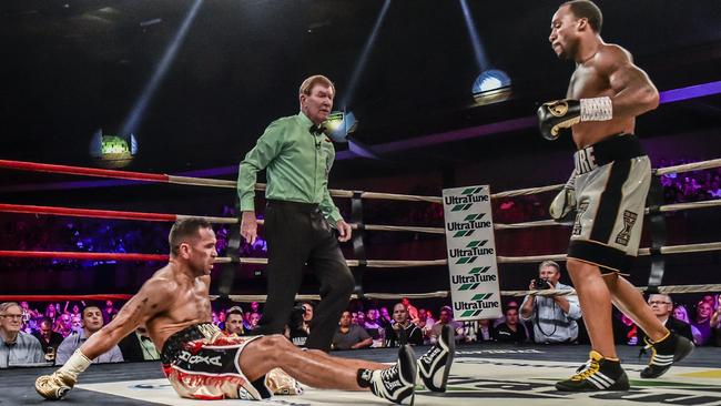 Anthony Mundine gets knocked down by Charles Hatley in 2015. Picture: Jason Edwards