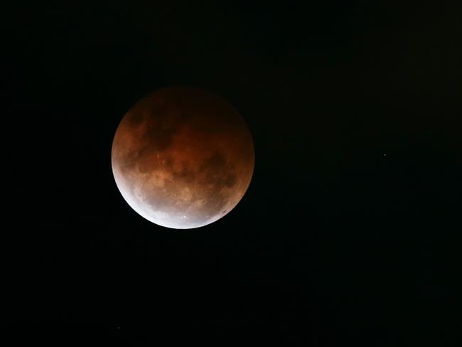 A full lunar eclipse was partially seen over Sydney tonight as low cloud prevented a clear view. Picture taken from St Leonards. Picture: Toby Zerna