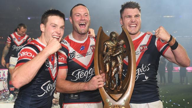 Luke Keary (left) celebrates back-to-back Roosters titles with captain Boyd Cordner and fellow former Rabbitoh Angus Crichton. Picture: AAP Image/Dan Himbrechts