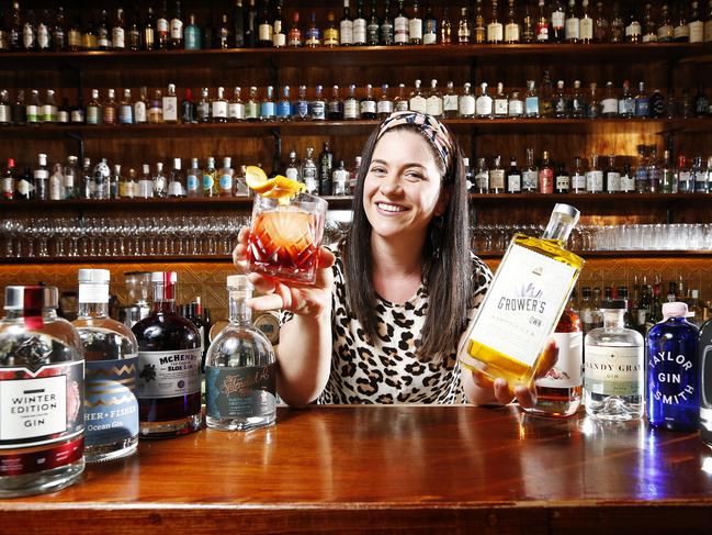 Owner of Society Ange Nichols with Tasmanian gins she stocks at her bar. Picture: Zak Simmonds