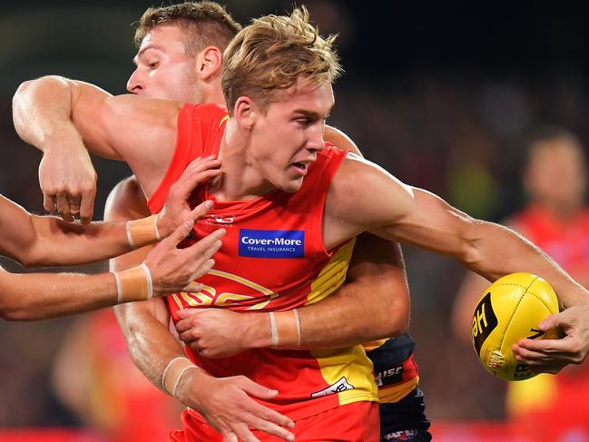 ADELAIDE, AUSTRALIA - APRIL 28: Tom Lynch of the Suns is tackled by Josh Jenkins of the Crows during the round six AFL match between the Adelaide Crows and Gold Coast Suns at Adelaide Oval on April 28, 2018 in Adelaide, Australia.  (Photo by Daniel Kalisz/Getty Images)