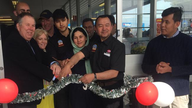 Port Adelaide Enfield Mayor Gary Johanson (left) opens the Khurasan Supermarket in Blair Athol with owner Hanif Rahimi (second from right), son Mujtaba, 21, and wife, Kamela. Picture: Eugene Boisvert