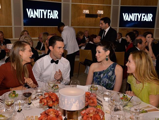 (L-R) Model Behati Prinsloo, musician Adam Levine, actresses Lauren Miller, and Leslie Mann attend the 2014 Vanity Fair Oscar Party Viewing Dinner.