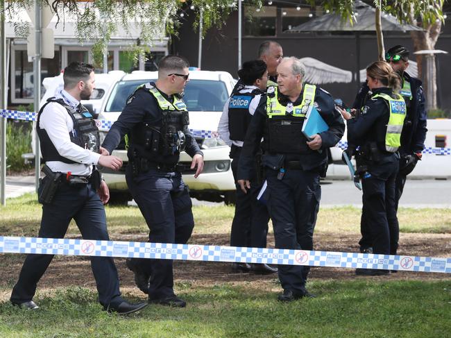 Police and homicide squad detectives at the scene of the shooting. Picture: David Crosling