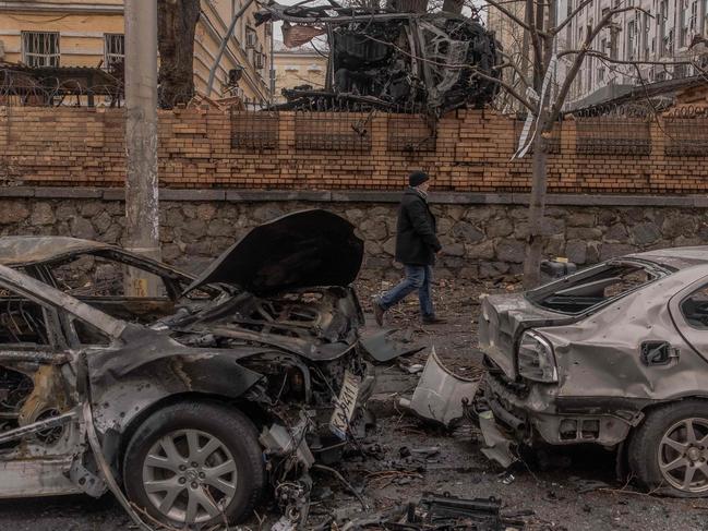 A man walks past destroyed cars following a missile attack in Kyiv. Picture: AFP