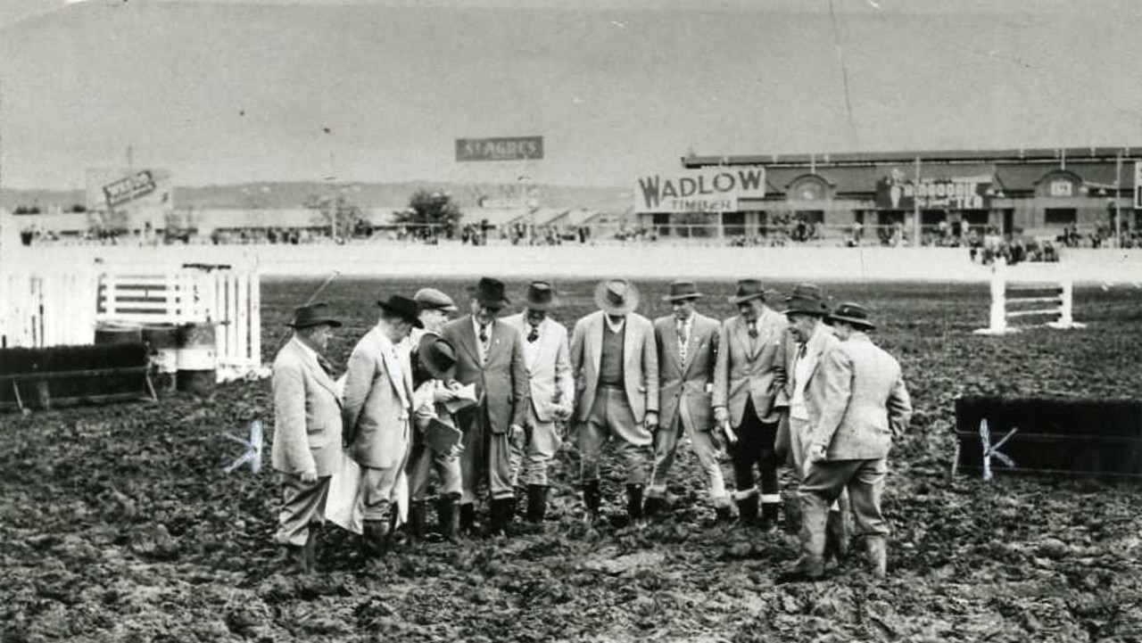 Royal Adelaide Show, 1956. Officials deciding whether to cancel the horses-in-action event due to the muddy arena. (The event went ahead).