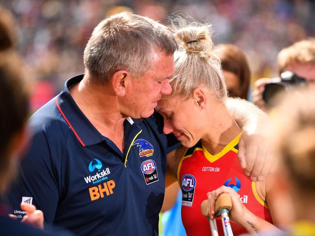 Erin Phillips is consoled by dad Greg after he injury.