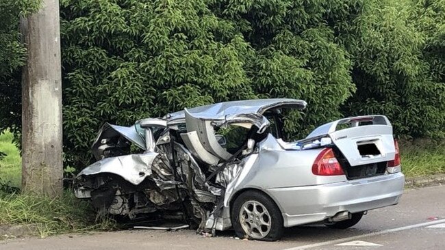 The silver Mitsubishi Lancer after it collided with a tree and a pole. Picture: supplied