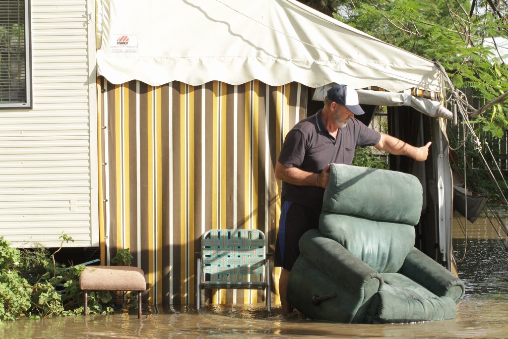 Wallace Caravan Park owner manager John Kennedy tries to save what furniture he can from a residents van. Photo: Robyne Cuerel / Fraser Coast Chronicle. Picture: Robyne Cuerel