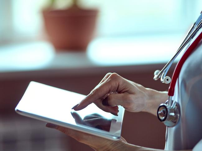 Woman doctor using tablet computer in hospital