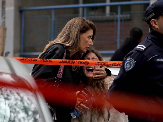 Emotions were high outside the school. (Photo by Oliver Bunic / AFP)