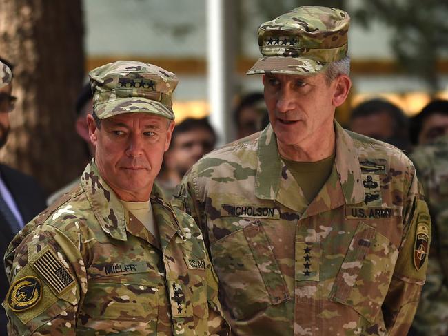 Incoming General Scott Miller (L), command of US and NATO forces in Afghanistan and outgoing U.S. Army General John Nicholson (R) look on during a change of command ceremony at Resolute Support in Kabul on September 2, 2018. - General Scott Miller took command of US and NATO forces in Afghanistan on September 2, as worsening violence erodes hopes for peace in the war-torn country. (Photo by WAKIL KOHSAR / AFP)