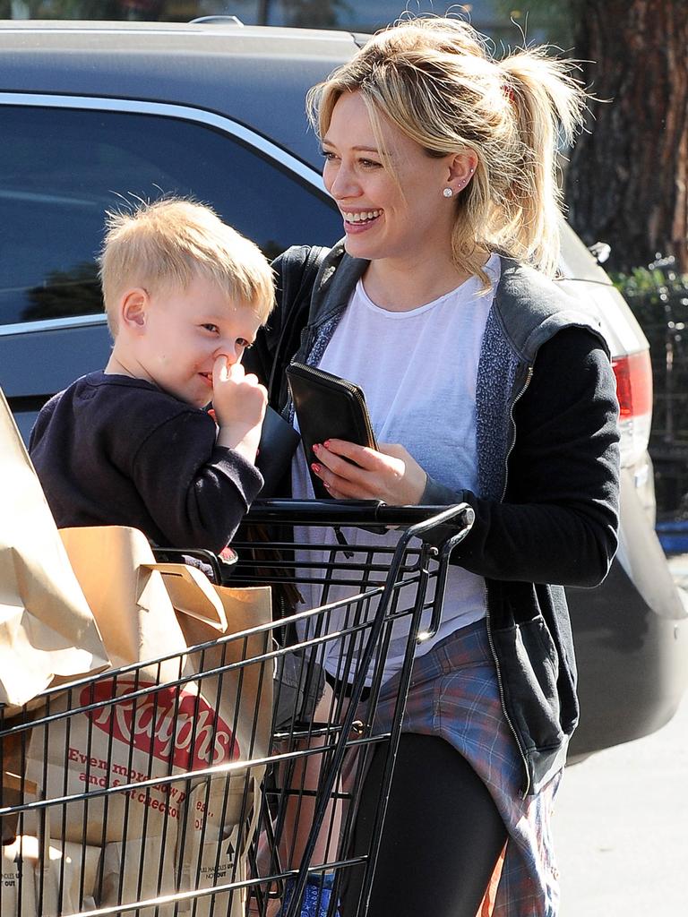 Giggles.. Hilary Duff stocks up on groceries with her son Luca.