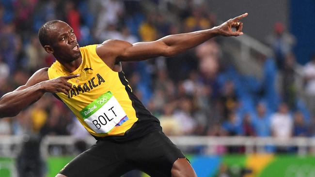 (FILES) Jamaica's Usain Bolt does his "Lightening Bolt"pose after he won the Men's 200m Final during the athletics event at the Rio 2016 Olympic Games at the Olympic Stadium in Rio de Janeiro on August 18, 2016. Jamaica's Usain Bol best-known as "Lightning Bolt" smashed the world records at the Beijing Games in 2008 for the 100m and 200m, going on to better his times a year later and making him to date the record holder in both. (Photo by OLIVIER MORIN / AFP)