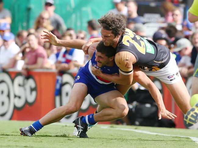 The tackle from Tiger Tyrone Vickey that saw Bulldog Tom Liberatore out of the game for 12 months with a ruptured ACL. Pic: Michael Klein
