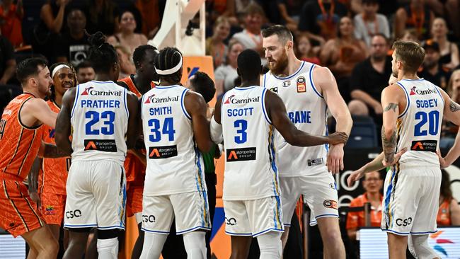 CAIRNS, AUSTRALIA - JANUARY 21: Aron Baynes of the Bullets is held by teammate Shannon Scott during the round 16 NBL match between Cairns Taipans and Brisbane Bullets at Cairns Convention Centre, on January 21, 2024, in Cairns, Australia. (Photo by Emily Barker/Getty Images)