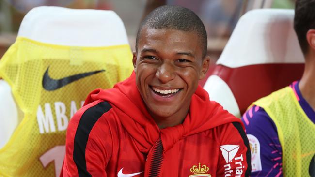 Monaco's French forward Kylian Mbappe sits on the bench.