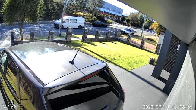 CCTV has captured the moment a black Holden Commodore fled police along on Gibbon Rd in Winston Hills on Thursday. Picture: Supplied