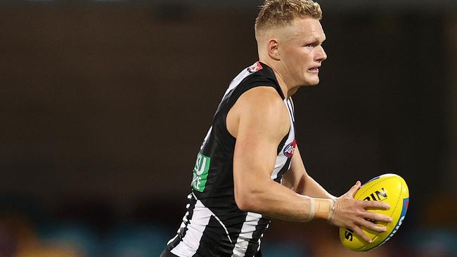 Adam Treloar on the run for Collingwood against Brisbane.