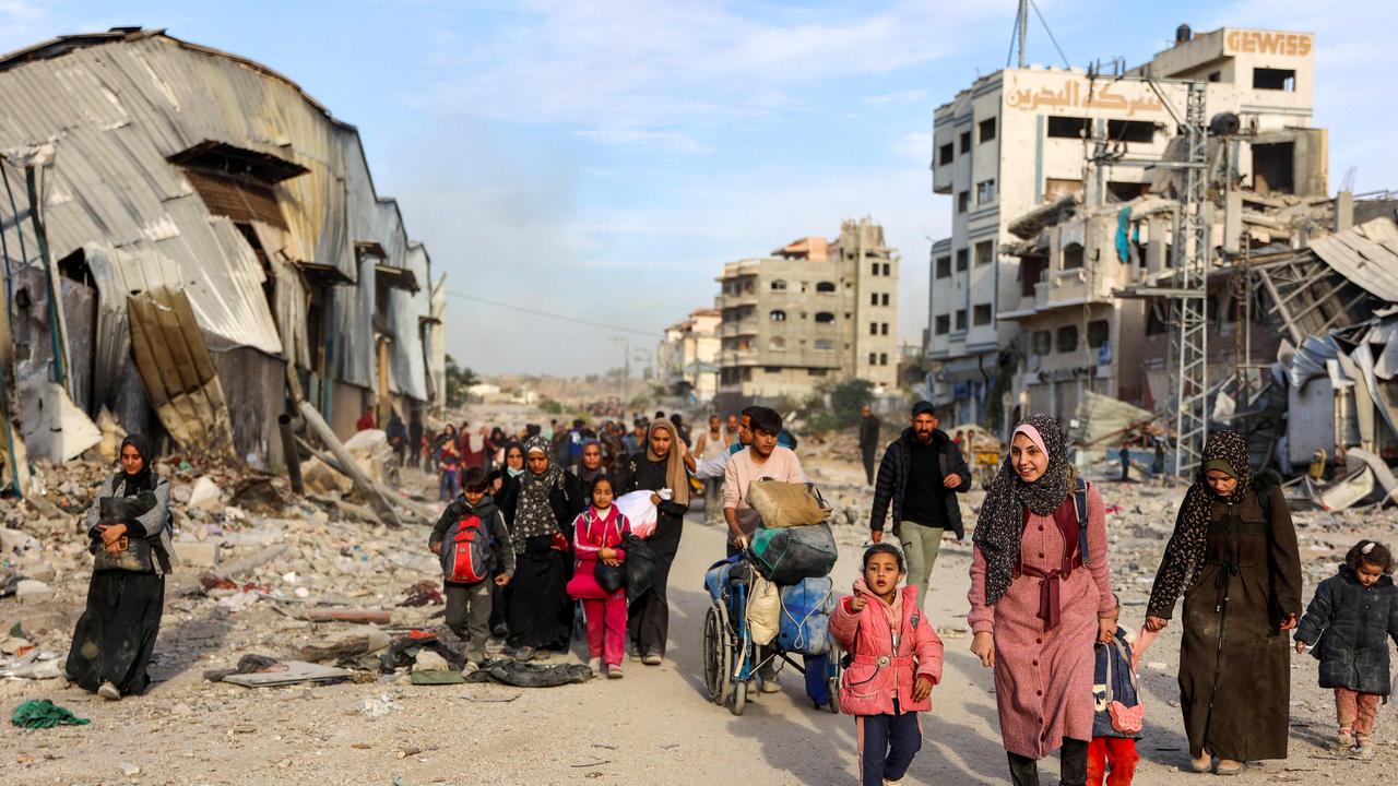 Displaced Palestinians fleeing Beit Lahia in the northern Gaza Strip walk on the main Salah al-Din road on November 17. Picture: Omar Al-Qattaa/AFP