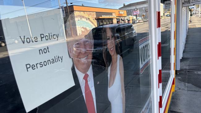 Next to a cardboard cut pout of Donald and Melania Trump is an entreaty to ‘vote police, not personality’. Picture: Benedict Brook.