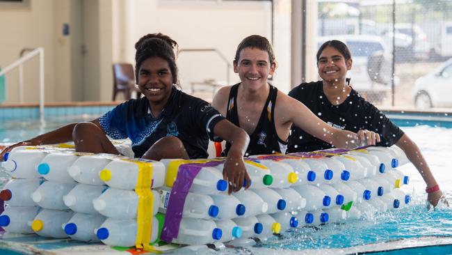 Henbury School students Natalia, Jade, and Dennis prepare their boat for the Beer Can Regatta, 2024. Picture: Pema Tamang Pakhrin