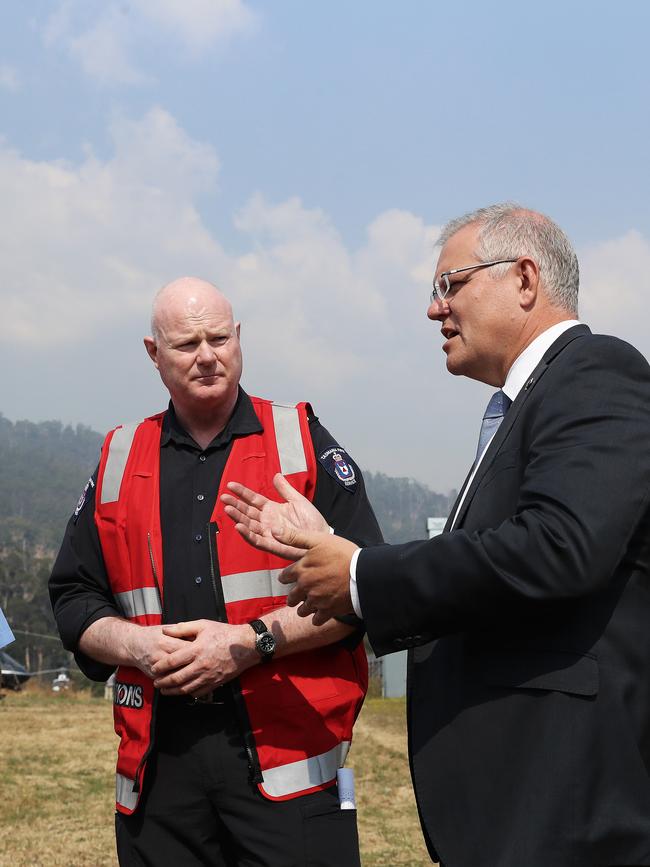 Mr Morrison chats with the Tasmania Fire Service's Phil Smith. Picture: LUKE BOWDEN