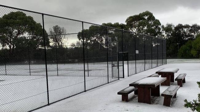 Tennis courts and picnic tables blanketed in hail. Picture: Brad Richards