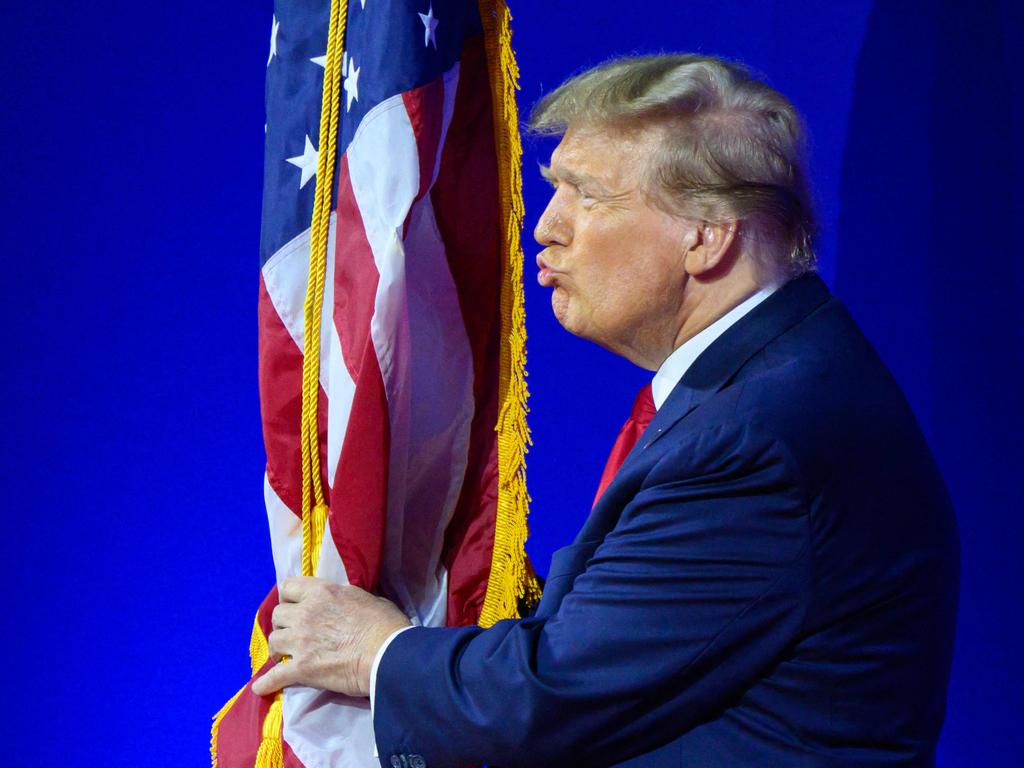 Former US president and 2024 presidential hopeful Donald Trump kisses the US flag as he arrives to speak during the annual Conservative Political Action Conference (CPAC) meeting. Picture: AFP