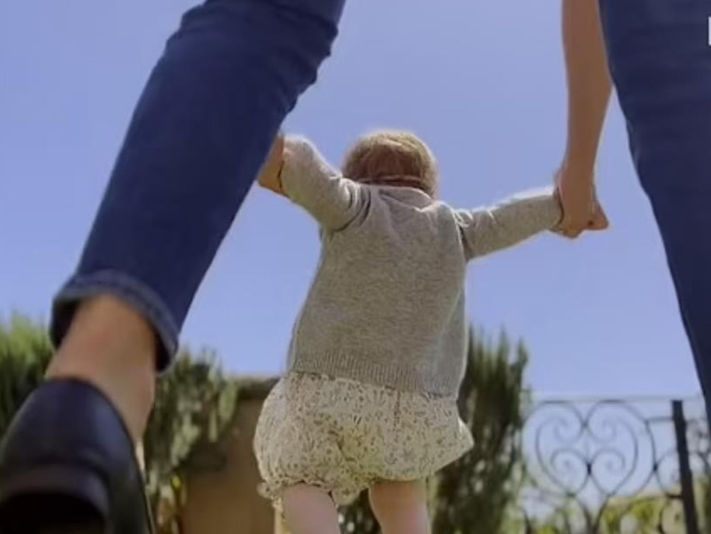 A previously unseen image shows toddler Lilibet trying to walk as mum Meghan holds her hands. Picture: Netflix