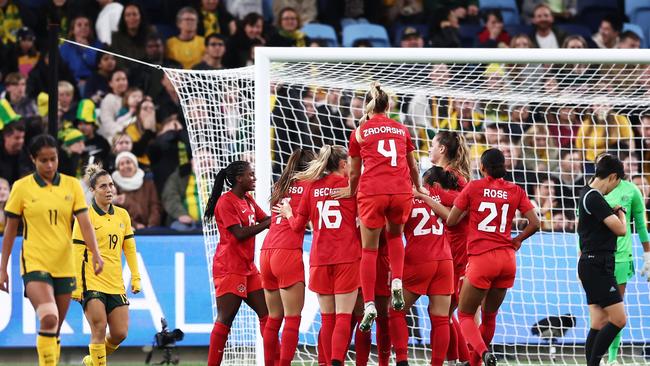 Canada celebrates one of its two goals against the Matildas on Tuesday.