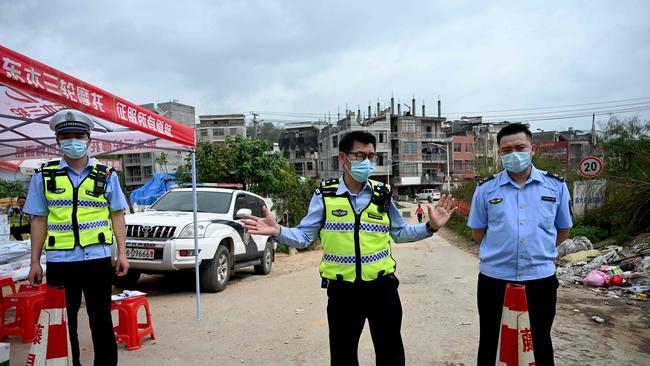 Policemen guard a checkpoint at Langnan village, in Wuzhou, near where the China Eastern flight MU5375 crashed on March 22.