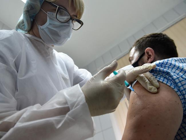 A nurse inoculates volunteer Ilya Dubrovin, 36, with Russia's new coronavirus vaccine in a post-registration trials at a clinic in Moscow on September 10, 2020. - Russia announced last month that its vaccine, named "Sputnik V" after the Soviet-era satellite that was the first launched into space in 1957, had already received approval. The vaccine was developed by the Gamaleya research institute in Moscow in coordination with the Russian defence ministry. (Photo by Natalia KOLESNIKOVA / AFP)