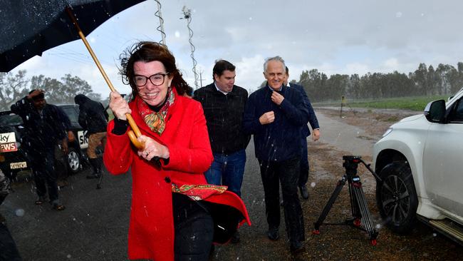 SA Senator Anne Ruston holds an umbrella while Prime Minister Malcolm Turnbull gets soaked by rain during his visit to flooded Virginia. Pic: Mark Brake