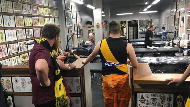 Fans line up to get tattoos tonight. Picture: Peter Rolfe