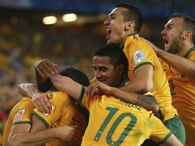 SYDNEY, AUSTRALIA - JANUARY 31: Tim Cahill, Jason Davidson and Ivan Franjic of Australia celebrate after Massimo Luongo of Australia scored his teams first goal during the 2015 Asian Cup final match between Korea Republic and the Australian Socceroos at ANZ Stadium on January 31, 2015 in Sydney, Australia. (Photo by Ryan Pierse/Getty Images)