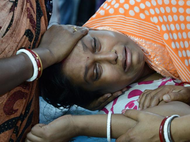 Indian resident Lucy Singh Biswas is comforted by relatives at Siliguri Hospital after she broke her leg by falling down stairs when an earthquake hit Siliguri on April 13, 2016 Myanmar was struck by a magnitude 6.9 quake on April 13, the US Geological Survey reported, with tremors in India and China sending residents rushing out into the streets. / AFP PHOTO / DIPTENDU DUTTA