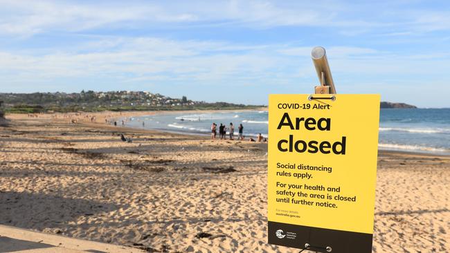 People on Dee Why Beach on Sunday afternoon despite the “Area Closed” signs put up by the Northern Beaches Council. Picture: Damian Shaw