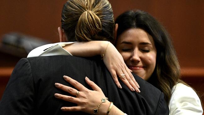 Depp’s attorney Camille Vasquez embraces the actor Johnny Depp in the courtroom.