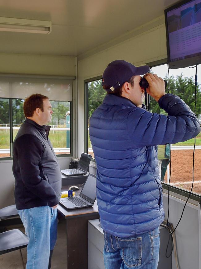 Trainers check progress on the hill track. Photo: Tony Gough