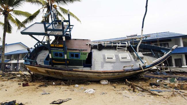 In the village of Hikkaduwa a fishing boat sat damaged and marooned in the ground of a tourist hotel. Picture: John Wilson