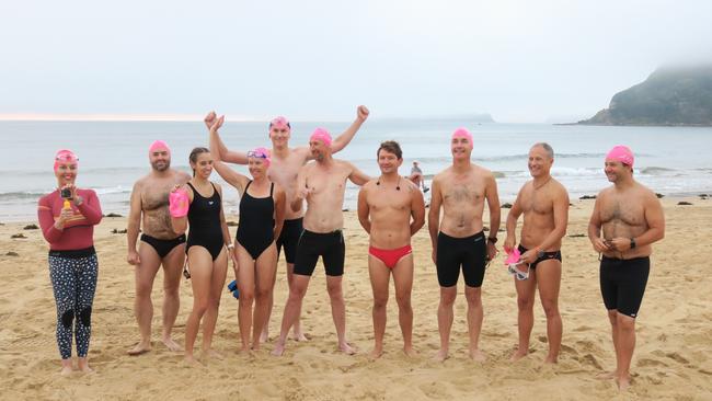 Members of the Peninsula Ocean Swimmers group get ready to attempt to swim around Lion Island, obscured by fog in the background. Picture: Richard Noone