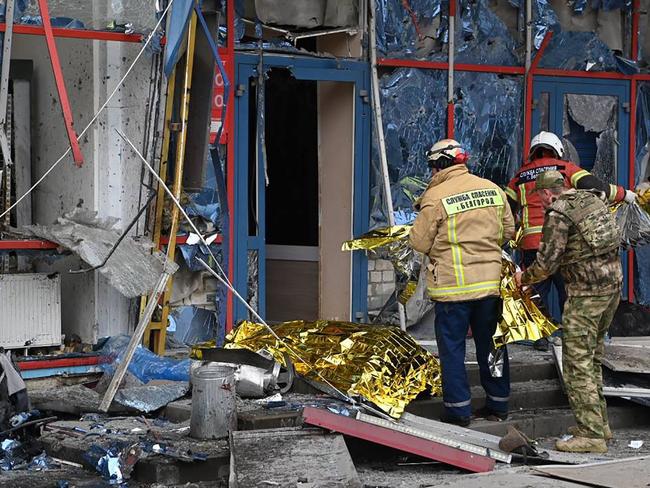 This handout photograph published on the official Telegram account of Belgorod region governor Vyacheslav Gladkov, on February 15, 2024, shows rescuers working at a damaged shopping centre following an air attack on Belgorod. At least five people were killed and 18 wounded in an air attack on the Russian city of Belgorod near the Ukrainian border, regional governor Vyacheslav Gladkov said on February 15, 2024. (Photo by Handout / Telegram / @vvgladkov / AFP) / RESTRICTED TO EDITORIAL USE - MANDATORY CREDIT "AFP PHOTO /  TELEGRAM ACCOUNT @vvgladkov" - NO MARKETING NO ADVERTISING CAMPAIGNS - DISTRIBUTED AS A SERVICE TO CLIENTS